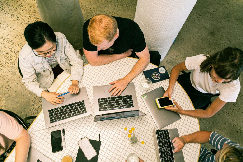 pexels-photo-3194521-3194521 Top view of diverse team collaboratively working in a modern office setting.
